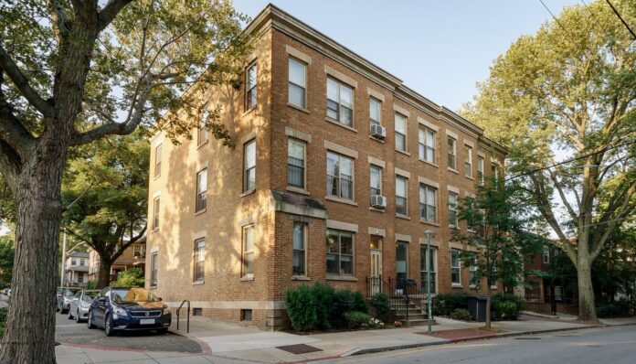 Firefly photograph of a well kept older mid rise workforce apartment building in a mixed resi 594738